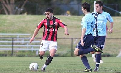 Boot to ball: Rockdale City Suns' Giorgio Speranza in the thick of the action in his team's loss against Marconi Stallions.Picture: Chris Lane