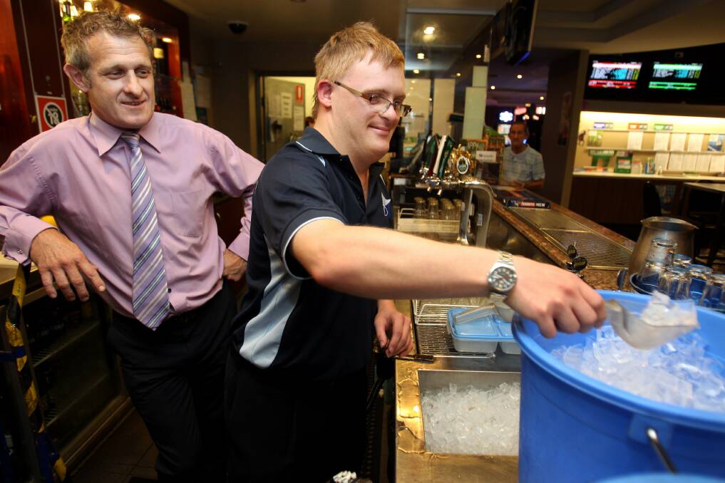 Star worker: Tom Maclachlan, of Jannali, celebrates four years at Bexley RSL this year after the club created a position for an intellectually disabled employee. He is pictured with Bexley RSL manager Anton Dworzak. Picture: Jane Dyson