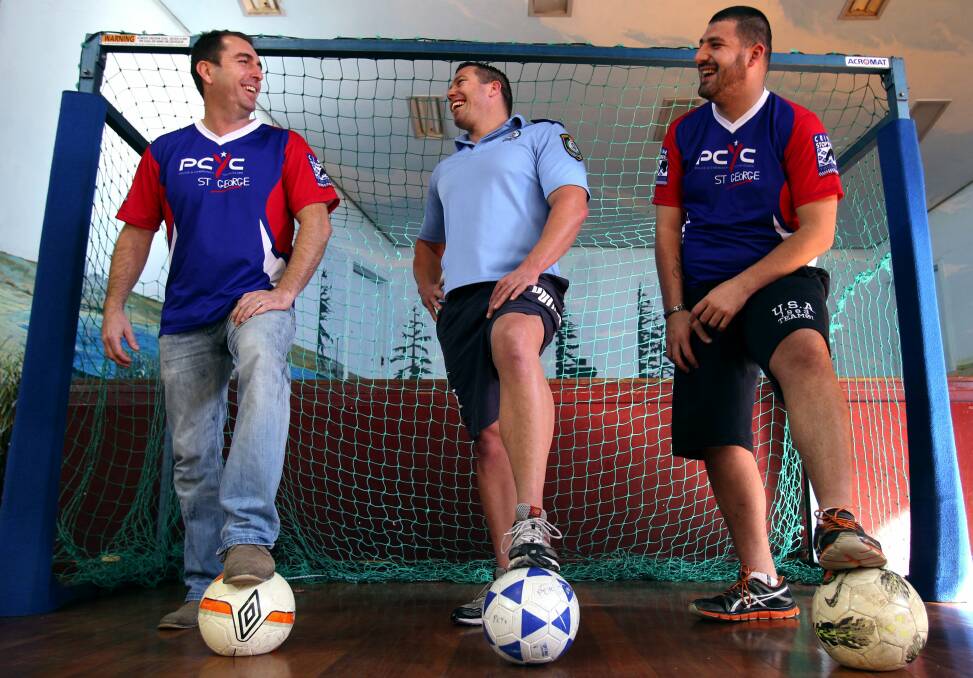 Kick it: St George PCYC is setting up a futsal league starting in August and helping out are (left) Jason Cursley, Sergeant Beaudie Cullen and Hassan Elzein. Picture: Jane Dyson