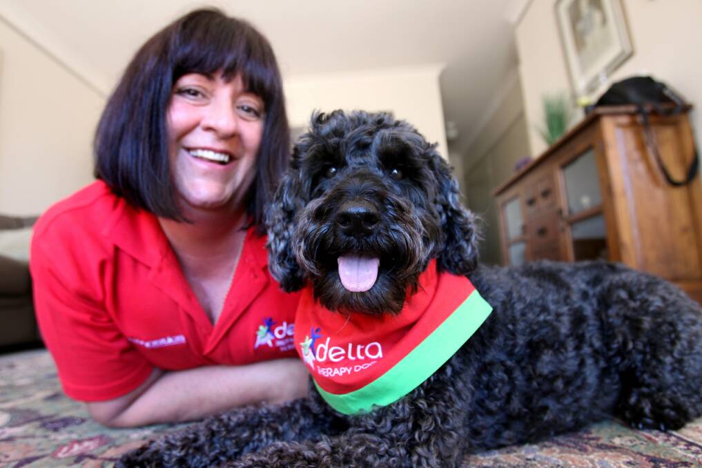 A dog's life: Oscar and Antoinette O'Sullivan volunteer their time to cheer up others. Picture: Jane Dyson