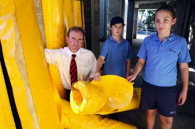 Why?: Principal of Illawong Public School Andrew Doyle and school captains Caitlin Docwra, 11, and Mitchell Shipp, 12, inspect the damage to post pads which were slashed by vandals.