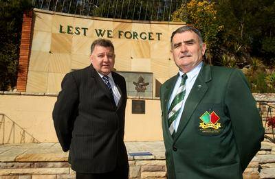 Ready for fight: Barry Grant, head of Australian Commando Association (right) is circulating a petition opposing federal government budget cuts to defence leave travel. He is pictured with Hughes MP Craig Kelly at the War Memorial outside the Woronora River RSL Club. Picture: Chris Lane 