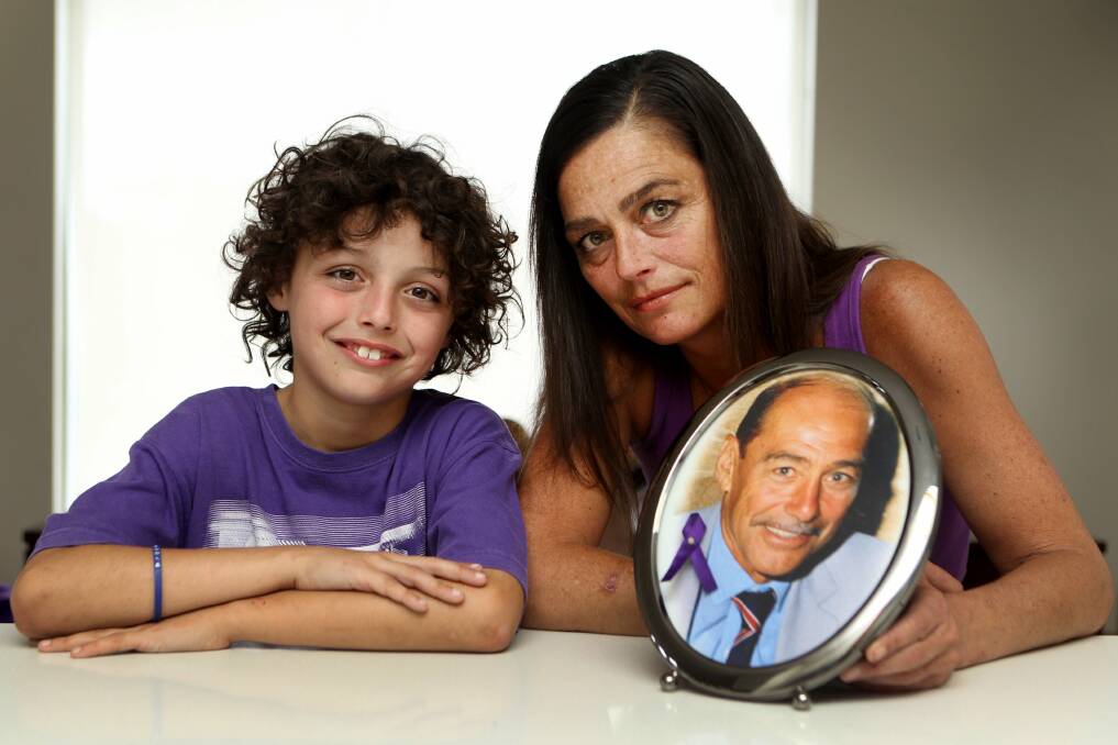 For Dad: Megan Barnes and son Cayden, 9, with a framed picture of her father, Brian Jones, who died last year. Picture: Lisa McMahon