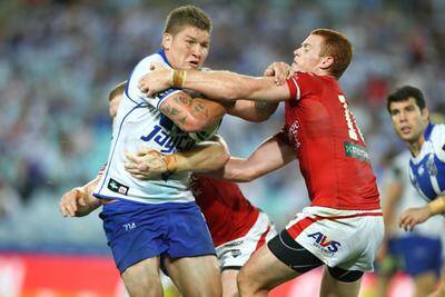 Got him: Nathan Green tries to bring down Bulldogs player Greg Eastwood during his debut match on Saturday night. Picture: Anthony Johnson 
