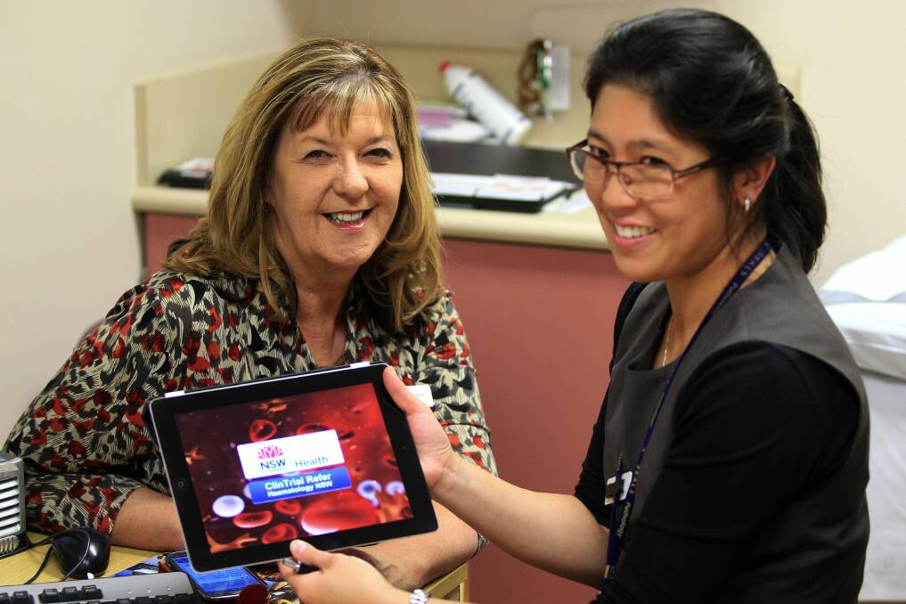In the red: Clinical trials unit manager Roslyn Ristuccia and Dr Shir-jing Ho check out the new app. Picture: John Veage
