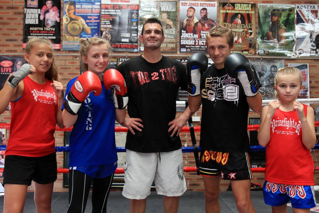 Fighting fit: Lolli Medcalf, Mirizza Medcalf, Axx Medcalf and Electra-Shenika Medcalf with their trainer, David Birchell. Picture: Chris Lane