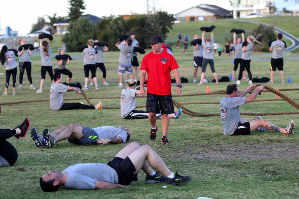 Stretching it: A fitness trainer puts a large group of clients through their paces at Lucas Reserve, Wanda recently. Picture John Veage