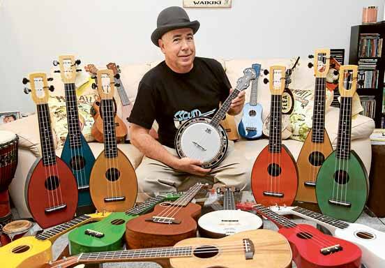Exploding interest: Ukulele teacher and performer John Chandler with just part of his collection of ukuleles. Picture: Lisa McMahon