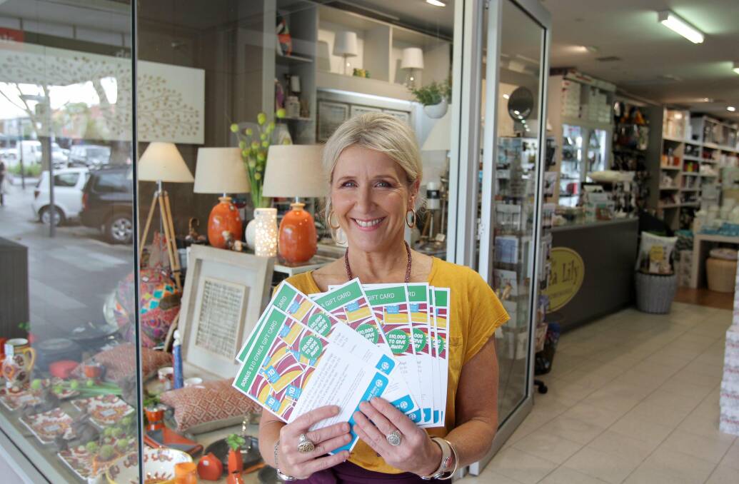 Gymea gets shopping: Gymea Lily shop owner Jo Morris gets ready for a promotion whereby shoppers get the chance to share in $10,000 worth of gift cards simply by shopping in the village. Picture: Chris Lane