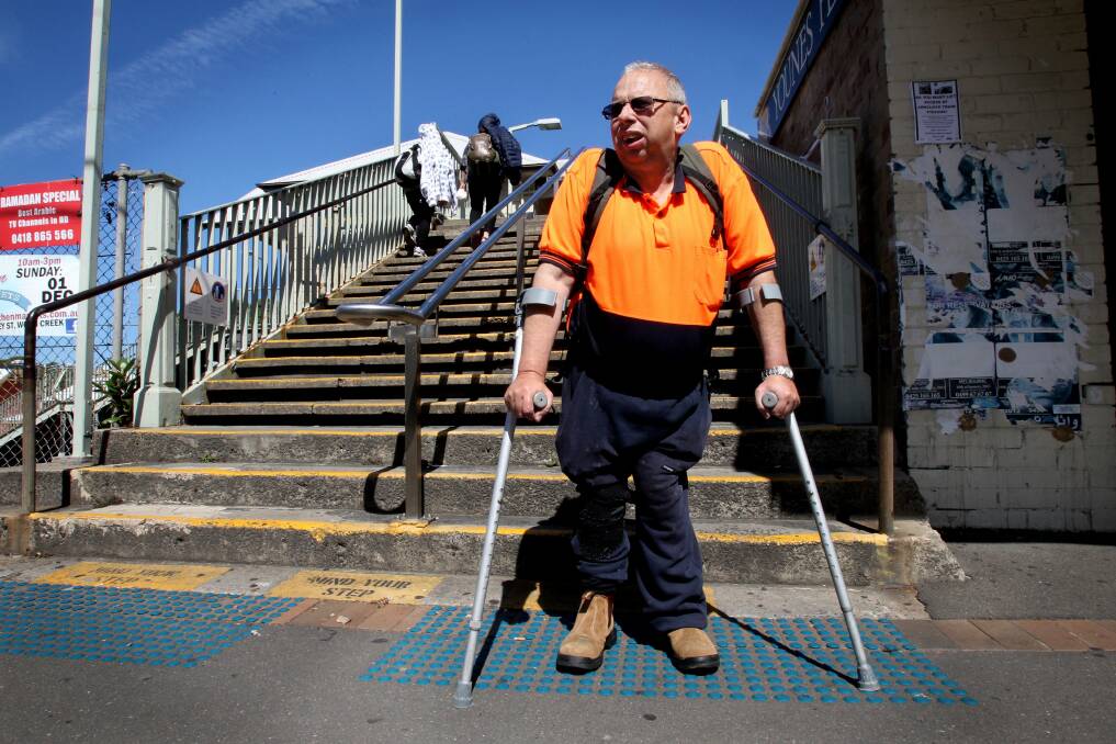 Hard yards: Commuter Craig Townsend struggles to get up the stairs at Arncliffe railway station. Picture: Jane Dyson