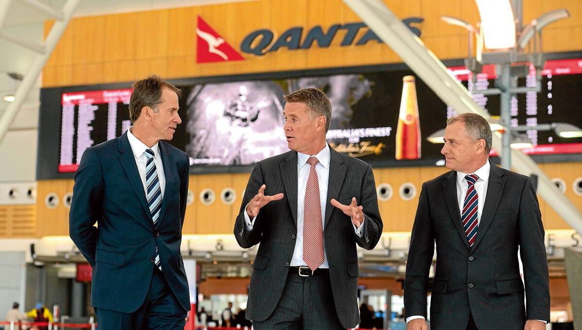 Lyell Strambi, Andrew Stoner and QantasLink executive John Gissing celebrate the move of QantasLink flights from Terminal 2 to Terminal 3 at Sydney airport yesterday.
