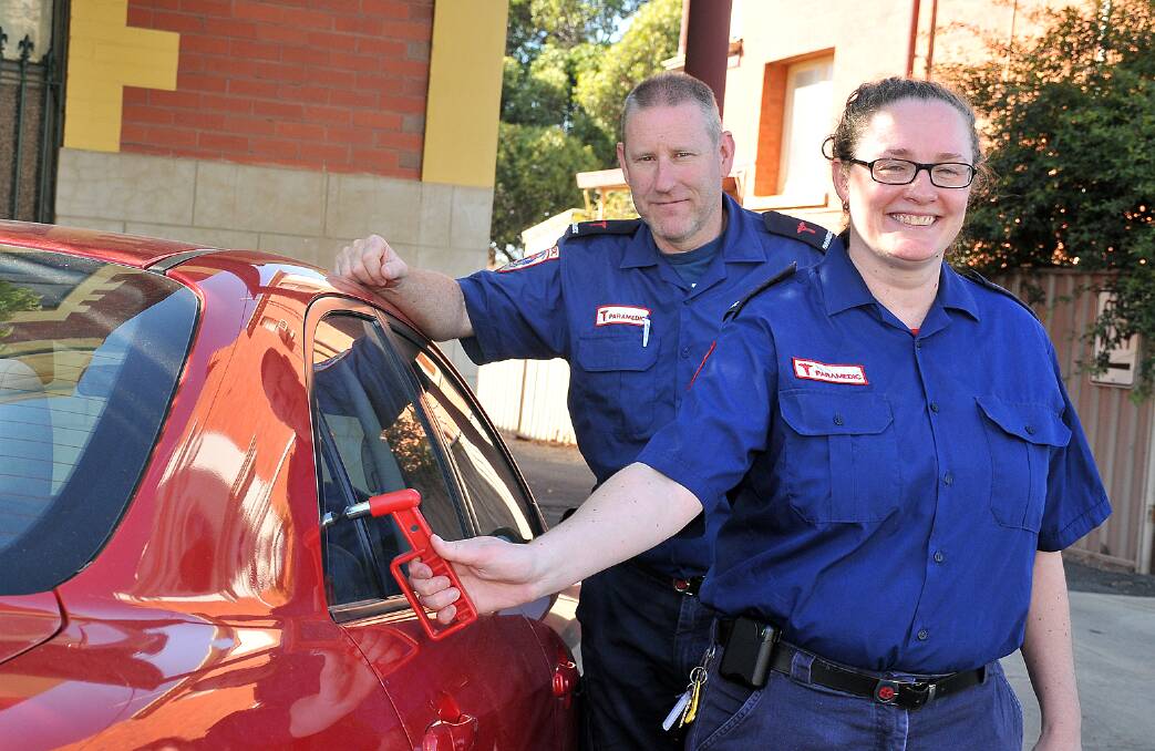 Stawell ambulance paramedics, Russell Pearson and Anna Barrett, demonstrate the tool that was used to break a rear window and rescue a baby from inside a locked car. Picture: KERRI KINGSTON.