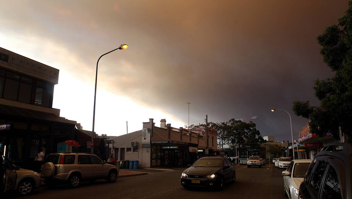 Smoke turned day into night at Kogarah, 4pm.  Leader photographer Jane Dyson took these shots as the sun appeared red through the clouds, reflected here in the St George Bank building (below) in Kogarah with a firey sky behind it.