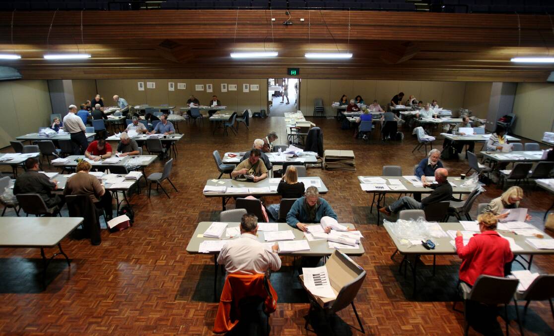 Counting continues: Election officials at Sutherland Entertainment Centre yesterday rechecking about 130,000 votes from the five wards of Sutherland Shire. Picture: Chris Lane 