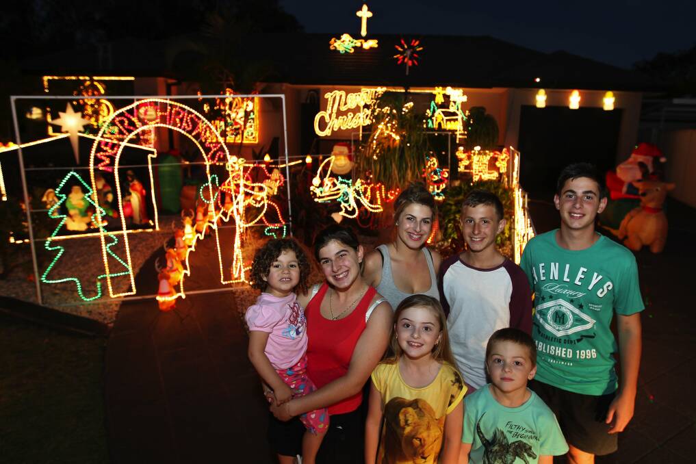 Wishing well: Enjoying Christmas lights at York Street, Kingsgrove, where a wishing well is raising funds for stroke research, is (back, from left) Alecia, Stephanie, Jennifer, Joshua, Jordan; and (front) Makayla and Christian. Picture: John Veage