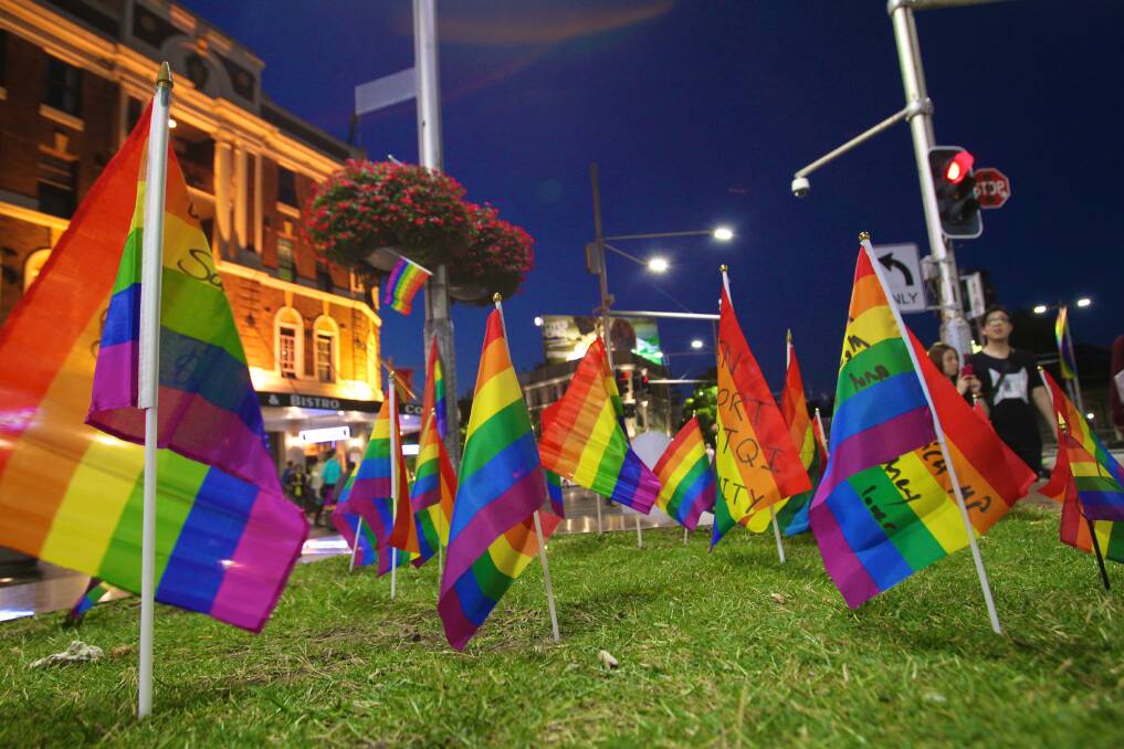 Not happy: Flags planted at Taylor Square as a protest about the removal of the rainbow coloured pedestrian crossing. Picture: Marco Del Grande