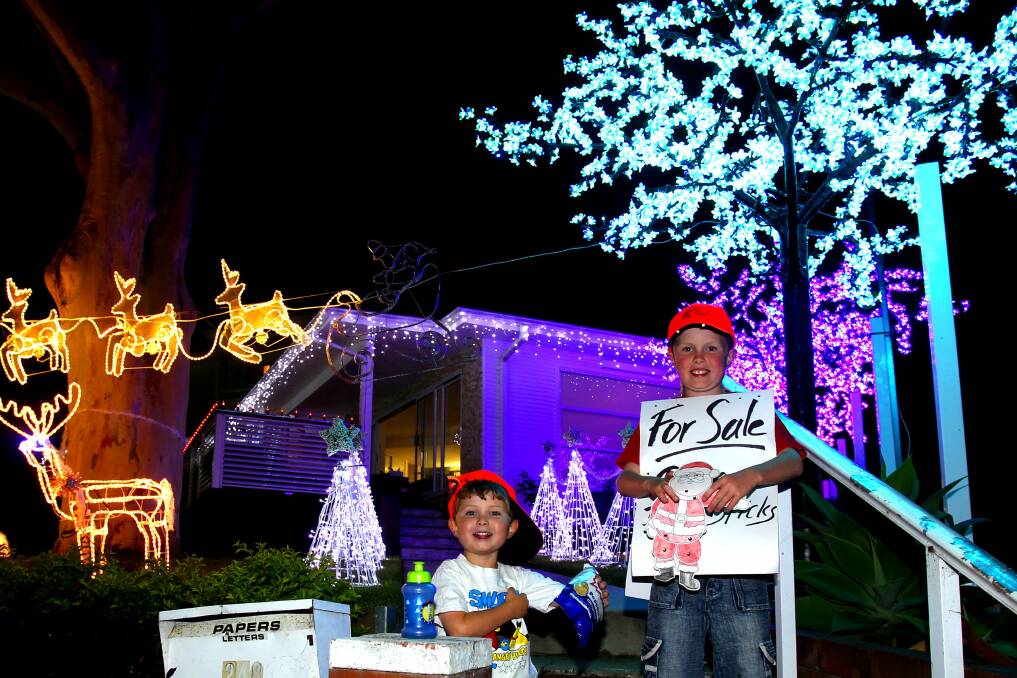 Will, 5, and Ben, 9, get into the Christmas spirit at Caringbah. Picture: Lisa McMahon