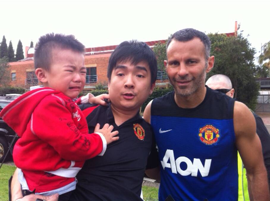 Big day out: Baby Hayden was a bit overwhelmed when he and dad Andry Himawan, who had been waiting since Tuesday morning,  got to meet Ryan Giggs