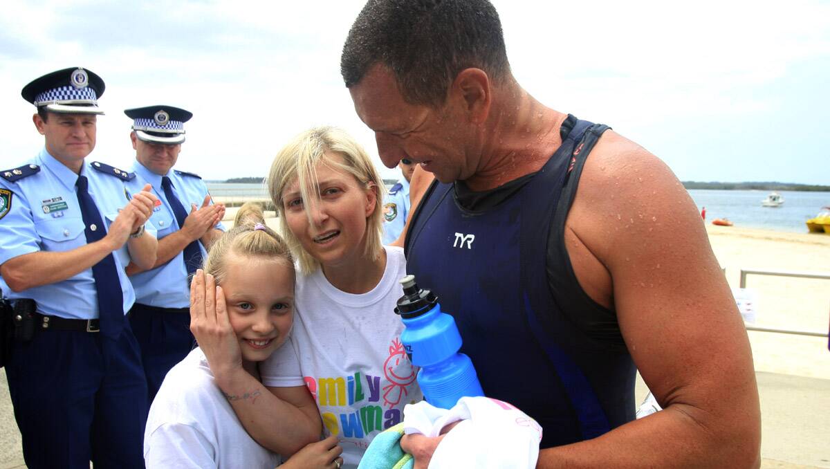 Thank you: Natalie and Emily Newman say thanks to St George top cop Superintendent Dave Donohue who swum eight kilometres from La Perouse to Dolls Point for them. Picture: James Alcock