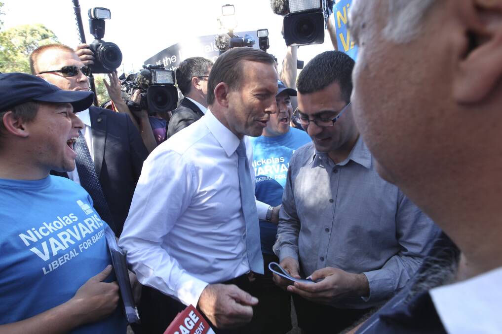Tony Abbott, who faced vocal protestors when he arrived at Athelstane Public school near Arncliffe to support Liberal candidate for Barton, Nicholas Varvaris. Picture: Nick Moir