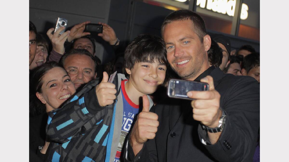 Walker poses for a photo with fans at the "Fast & Furious 5" premiere at UGC Cinema on April 29, 2011 in Rome, Italy. 