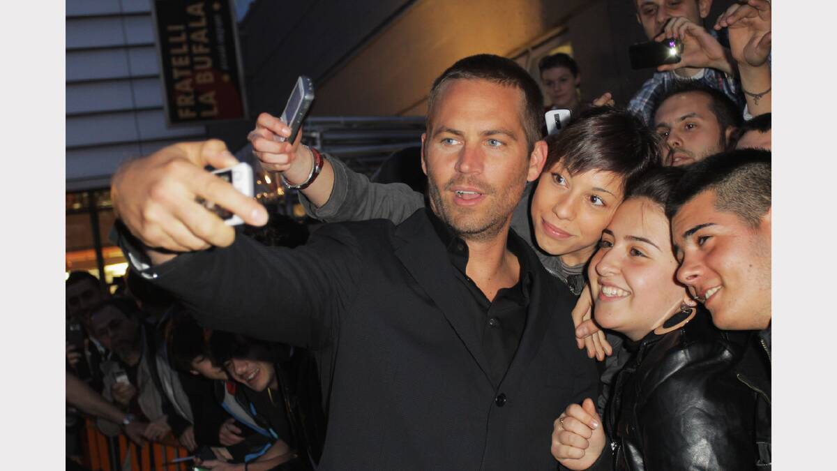  Walker takes a photo with fans at the "Fast & Furious 5" premiere at UGC Cinema on April 29, 2011 in Rome, Italy.  