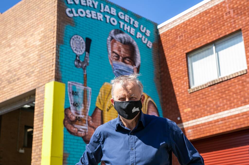 THEN AND NOW: Albanese outside Hawke's Brewing Company in Marrickville, in front of a Scott Marsh mural of former Labor PM Bob Hawke. .