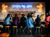 'SHOW US YA TIPS': Original neon signage adorns the Oxford Tavern's new front bar.