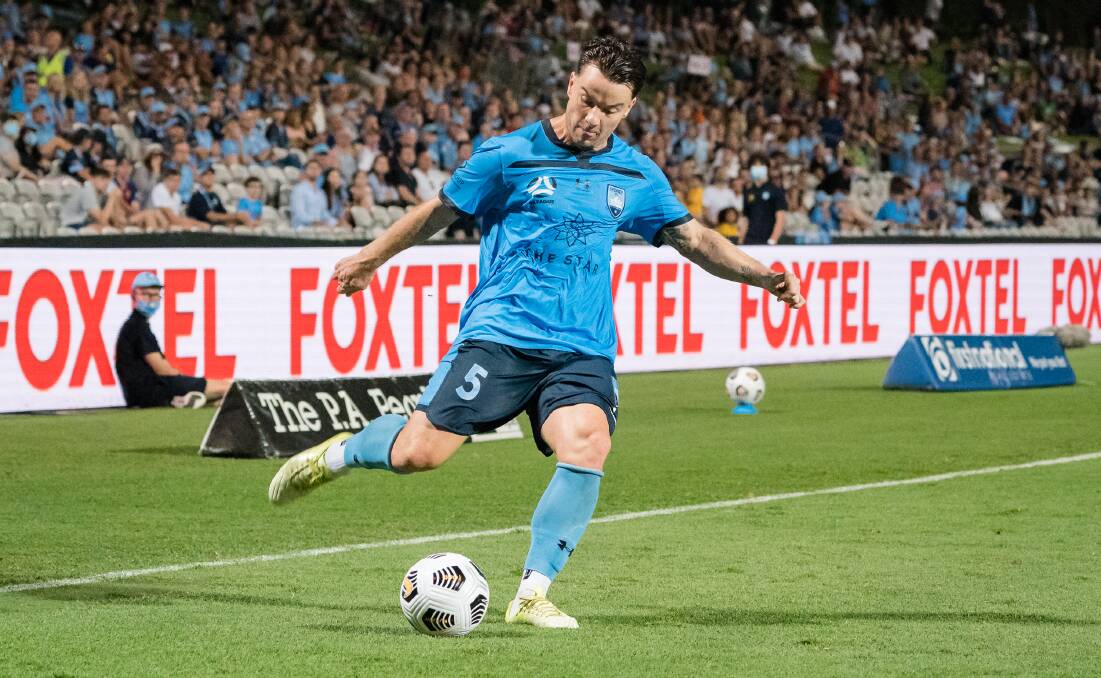 Finals bound: Alex Baumjohann crosses the ball for Sydney FC during their match against the Brisbane Roar. Picture: Jaime Castaneda.