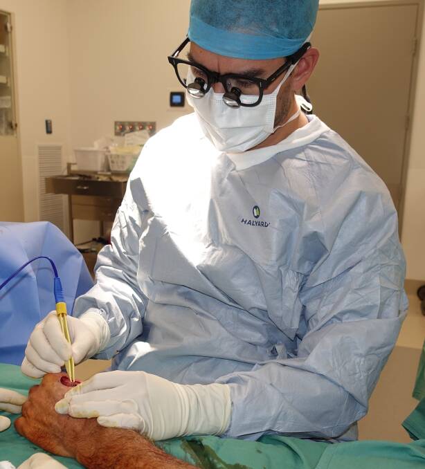 EXPERTISE AND COMPASSION: Dr Adrian Sjarif at work in the operating theatre.
