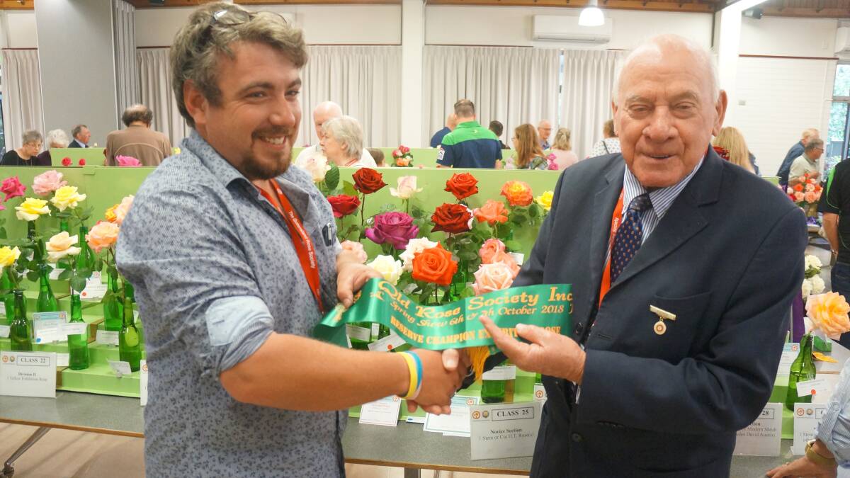 PROUD MOMENT: Braidan Swan receives his award from NSW Rose Society president Colin Hollis. 