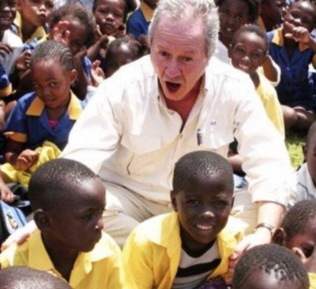 Alf Taylor gets an enthusiastic greeting on a visit to one of the schools his foundation built in Africa.