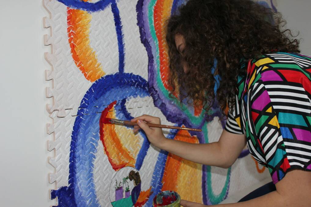 Artist Jamie Parmaxidis at work as part of Hurstville Museum and Gallerys Artbomb Connect + create exhibition, showing until July 26.