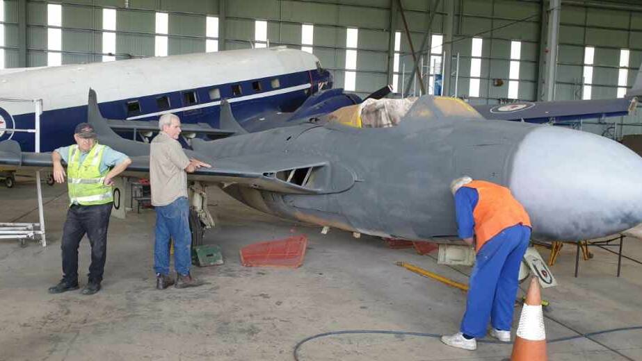 Volunteers at HARS Aviation Museum work to restore a former RAN Sea Venom for display. Photo: Ken Jackson