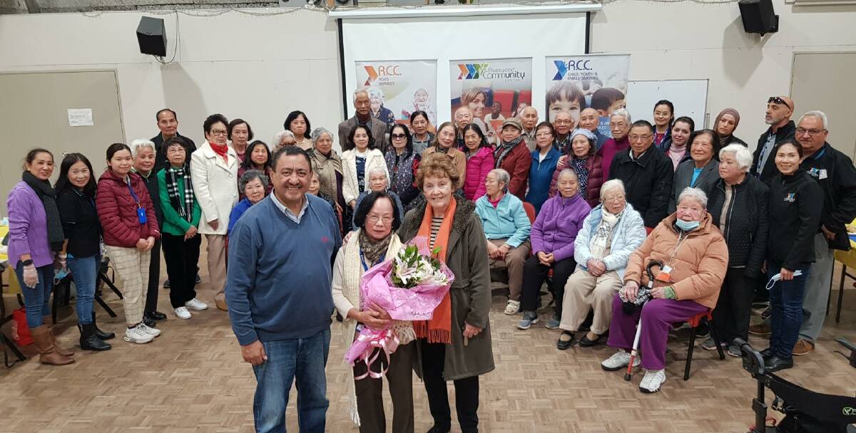 Legacy of hard work: Hang Trinh (centre) with Riverwood Community Centre chairman Karl Saleh and Pauline Gallagher, with the community members