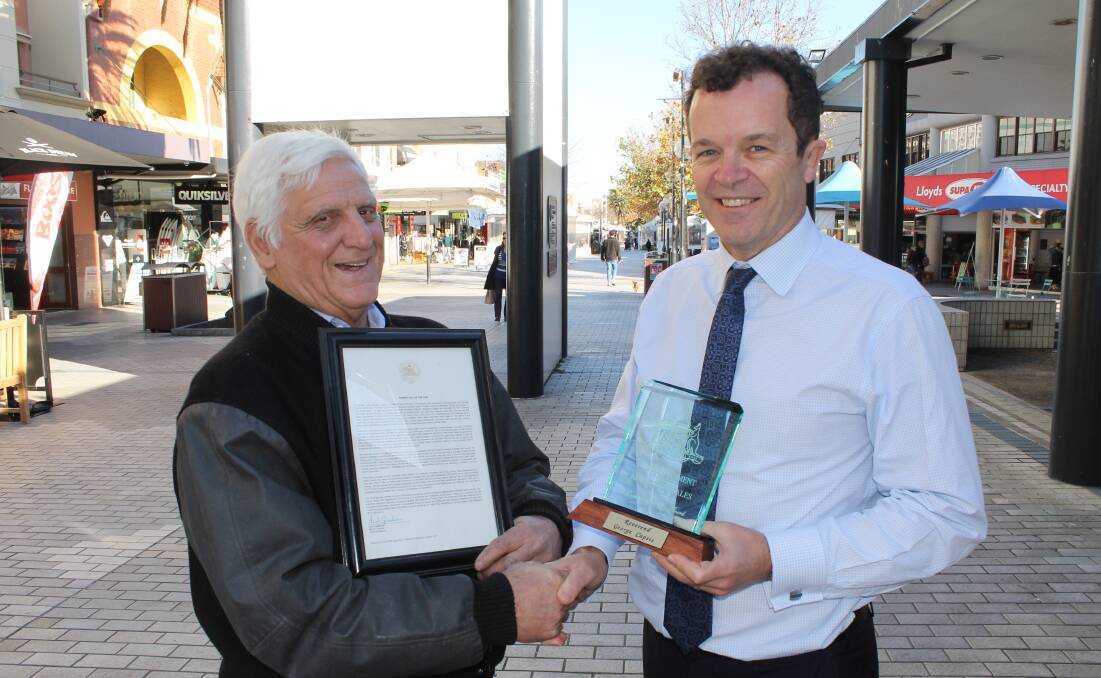 Deserving recipient: Reverend George Capsis receives his Community Service Award from Cronulla MP Mark Speakman.