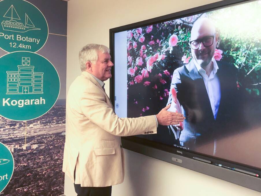 Handy work: Georges River Council mayor Kevin Greene taking part in a virtual handshake with David Craven, director of the Cities Power Partnership.