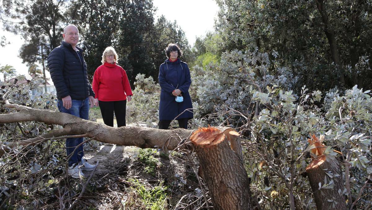 Destroyed: Bayside deputy mayor James Macdonald, Councillor Liz Barlow, and Brighton-Le-Sands resident Evelyn with one of the vandalised trees. Picture: John Veage
