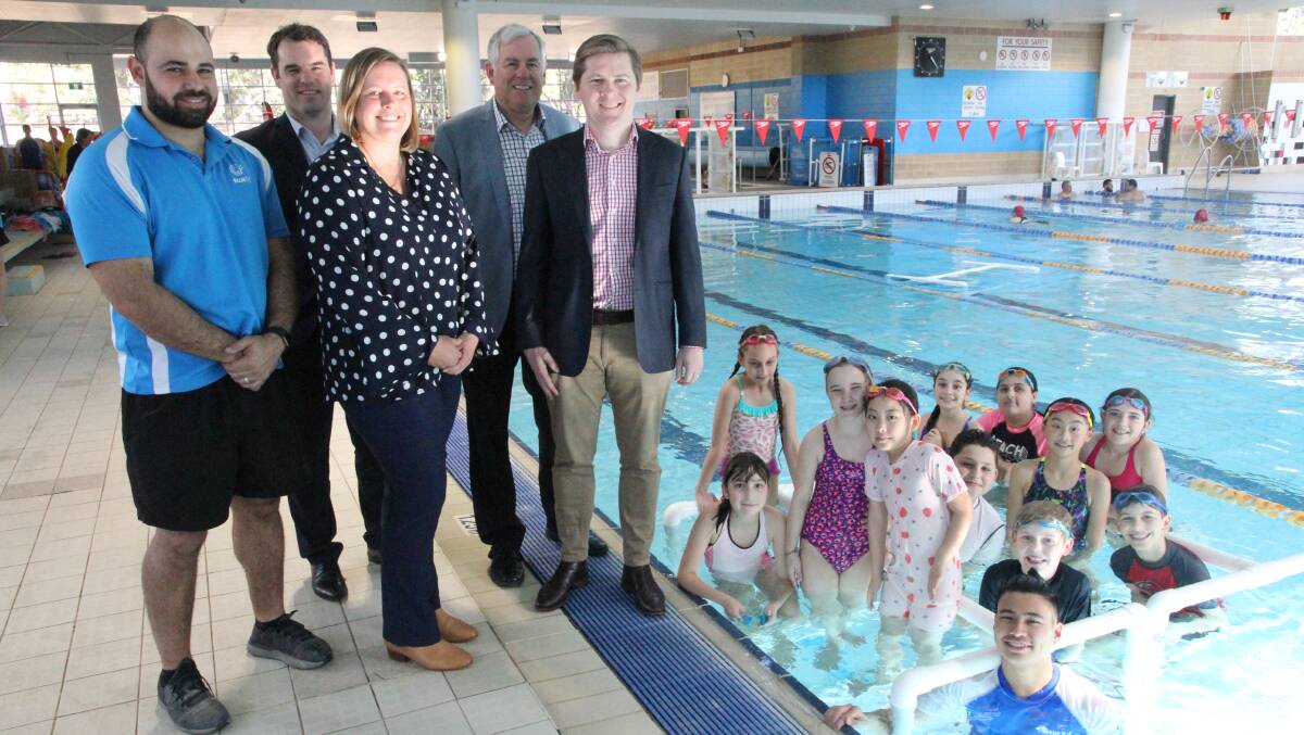 In the swim: Georges River mayor Kevin Greene and councillor Warren Tegg (right) with Bluefit staff and swimming clsss particiapants at Hurstville Aquatic Centre.