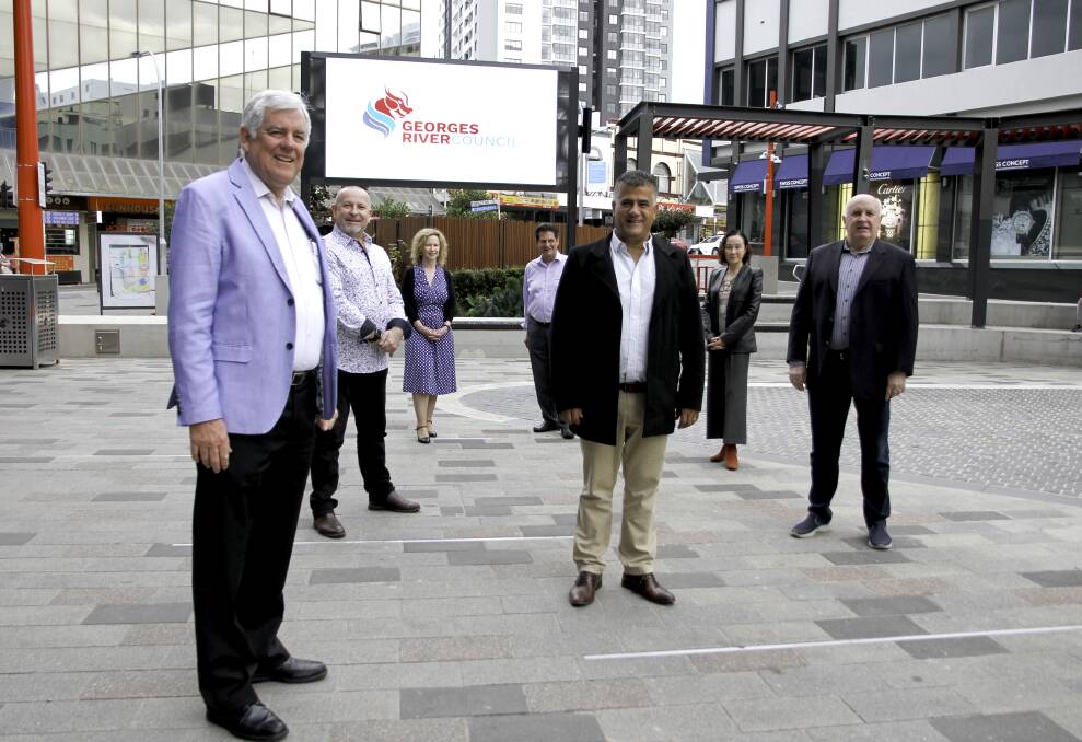 Screen time: Deputy Mayor Con Hindi (centre) originally called for the installation of the screen in Hurstville Plaza, so that the community could enjoy more entertainment options locally.