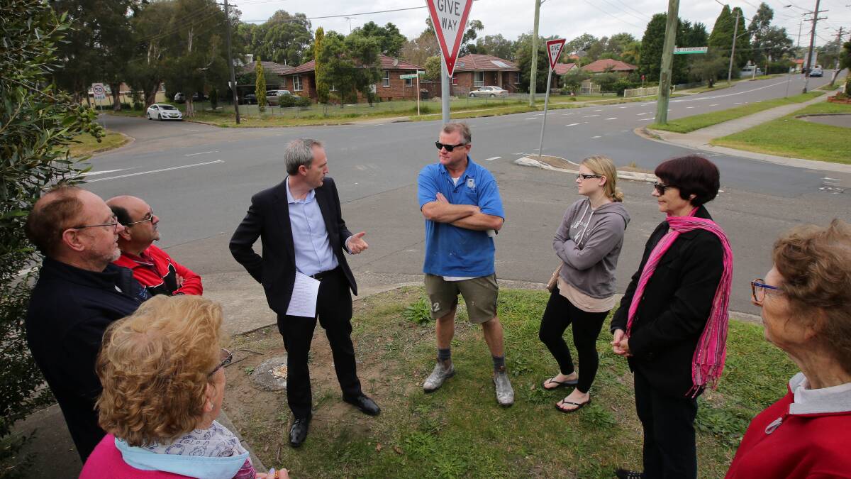 Concerns heard: Banks MP David Coleman discusses the 2017 budget allocation for the roundabout last year with residents at the corner of Belmore Road and Clarendon Road, Peakhurst. Picture: John Veage