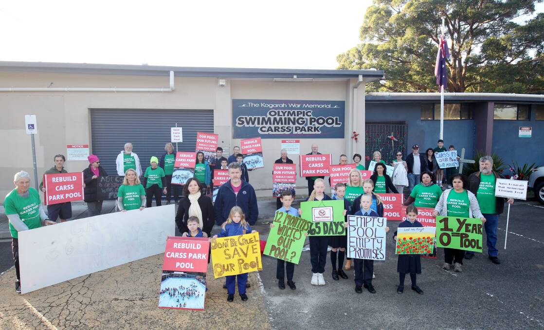 Protestors make their feelings known outside the Carss Park Pool this morning on the first anniversary of the pool's closure. Picture: Chris Lane