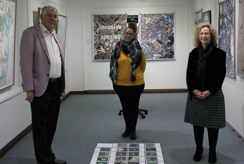 The art of helping: from left, Georges River Council mayor, Kevin Greene; artist, Soupsue;, and Councillor Colleen Symington at Hurstville Museum and Gallery.