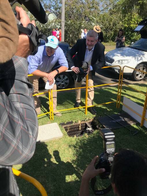Pit stop: Scott Morrison and Mitch Fifield watch the installation of the new NBN technology at Miranda.