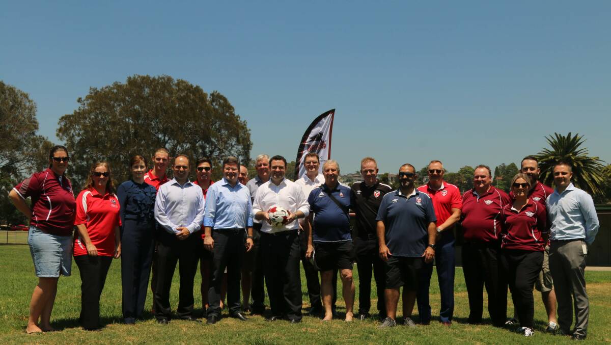 NSW Sports Minister Stuary Ayres (centre, white shirt) at the funding announcement for the new amenities block at Charles Pirie Reserve.