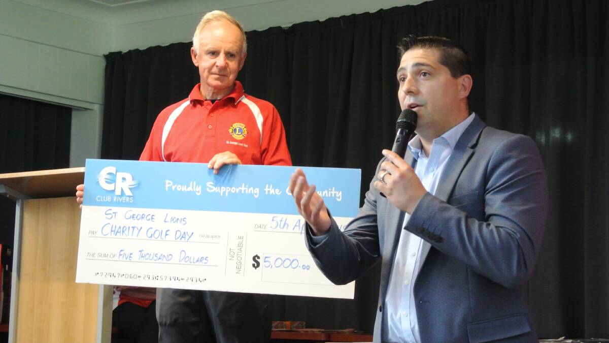 Charity golf day: St George Lions Club president John Craig accepts the $5000 donation from Club Rivers ceo Stuart Jamieson to support three significant community projects.