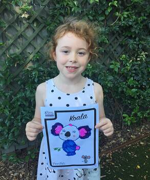 Amber, 7, with an example of her artwork she sent to her new pen pal through the Home Instead Pen Pal program.