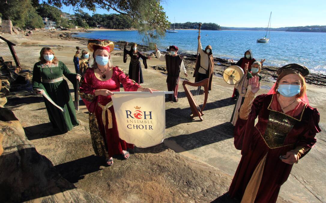 Medieval mask: The ROH Renaissance Choir on Bunbdeena Beach with masks. Picture: Justin Case