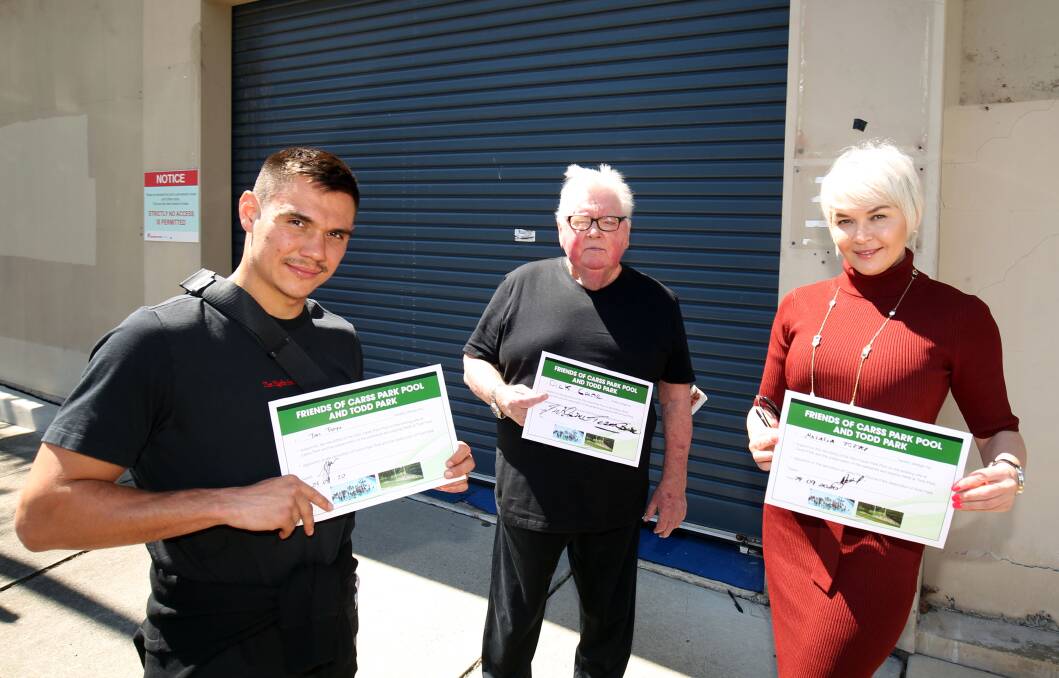 Taking the plunge and signing the pledge: Boxer Tim Tszyu, coach Dick Caine and Tim's mother, Natalie, with their pledges outside the Carss Park Pool. Picture: Chris Lane