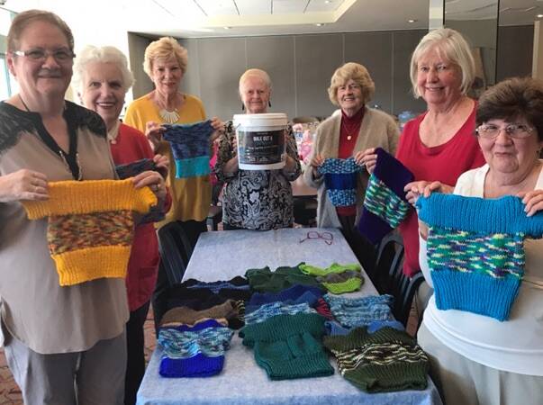 Jumping to it: Members of the Ramsgate RSL Ladies Social and Craft Club with the tiny jumpers that will be sent to drought-affected farmers for their orphaned lambs.